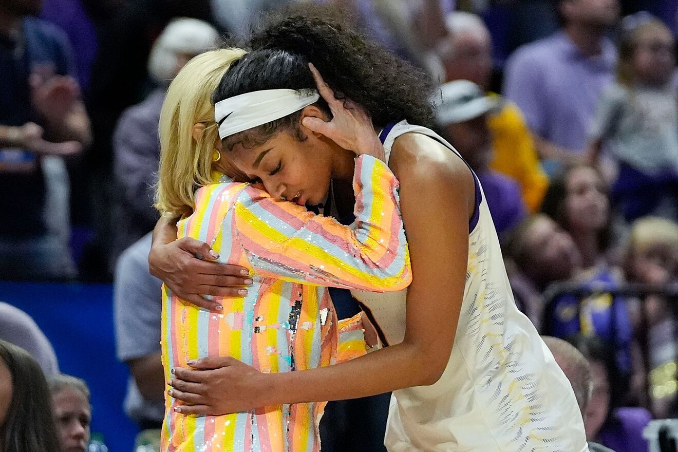 LSU head coach Kim Mulkey hugs forward Angel Reese.