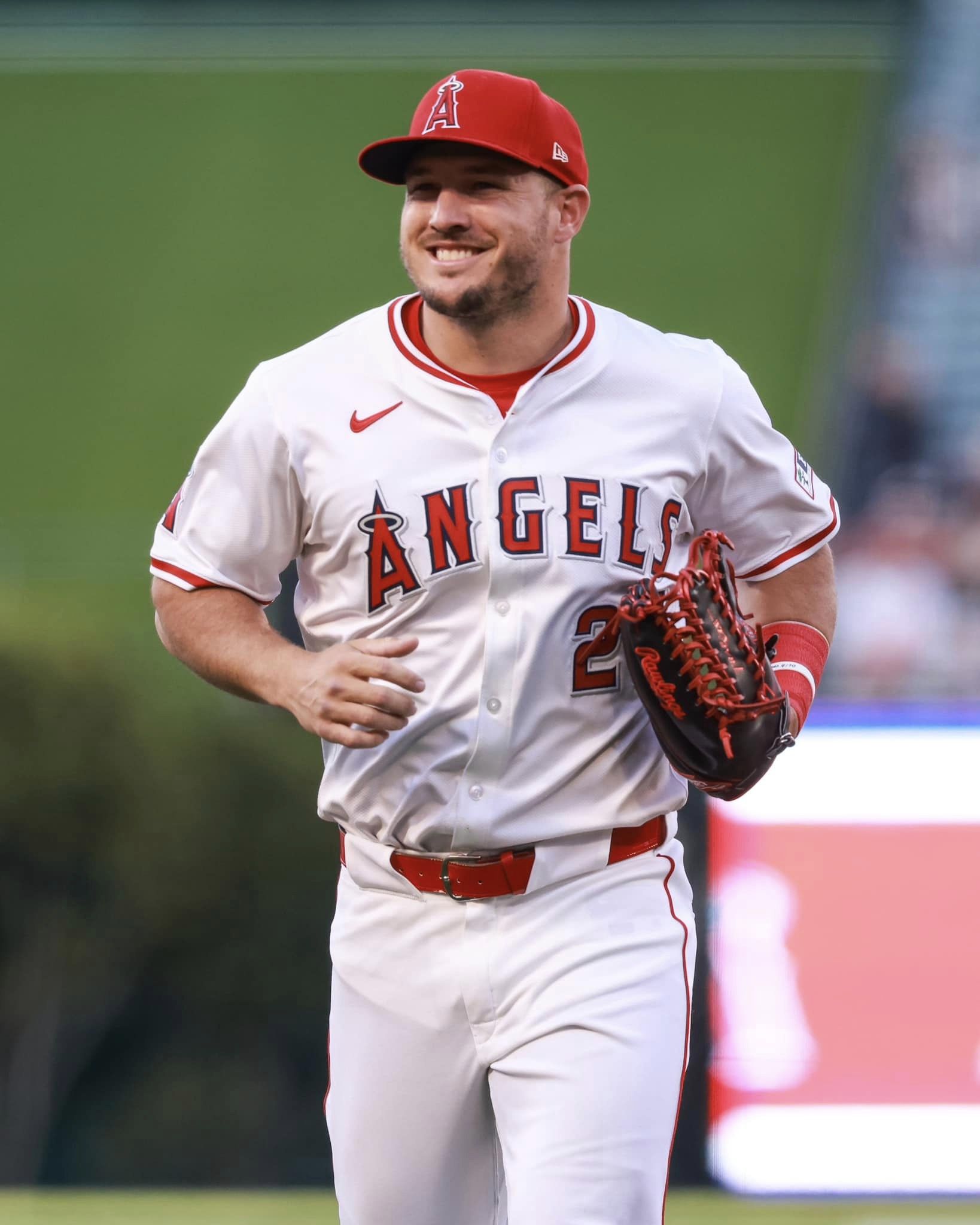 Trout smiles as he jogs off the field at the beginning of the game.