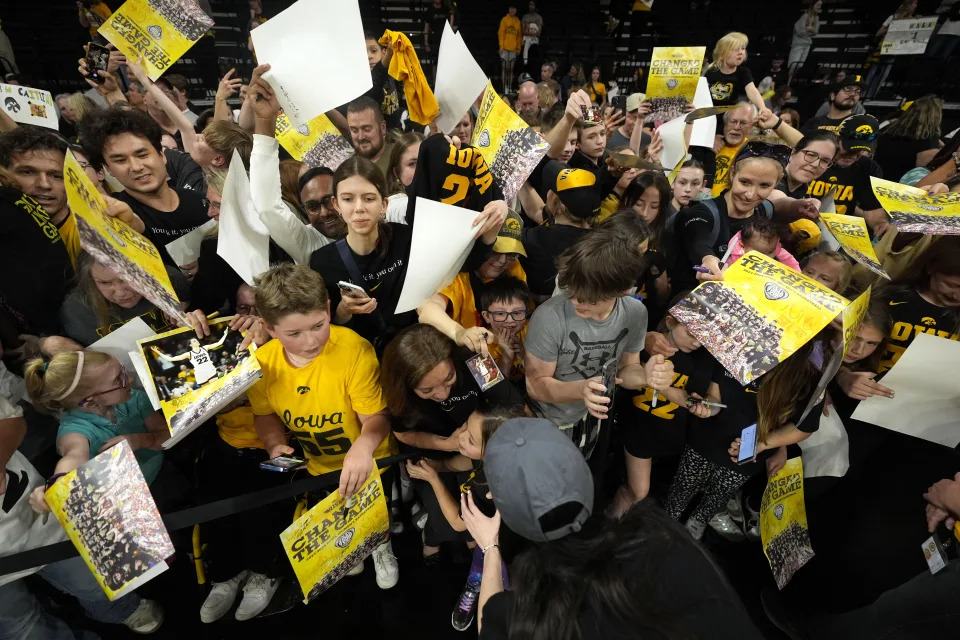 Iowa guard Caitlin Clark signs autographs during an Iowa women's basketball team celebration, Wednesday, April 10, 2024, in Iowa City, Iowa. Iowa lost to South Carolina in the Final Four college basketball championship game of the women's NCAA Tournament on Sunday. (AP Photo/Charlie Neibergall)