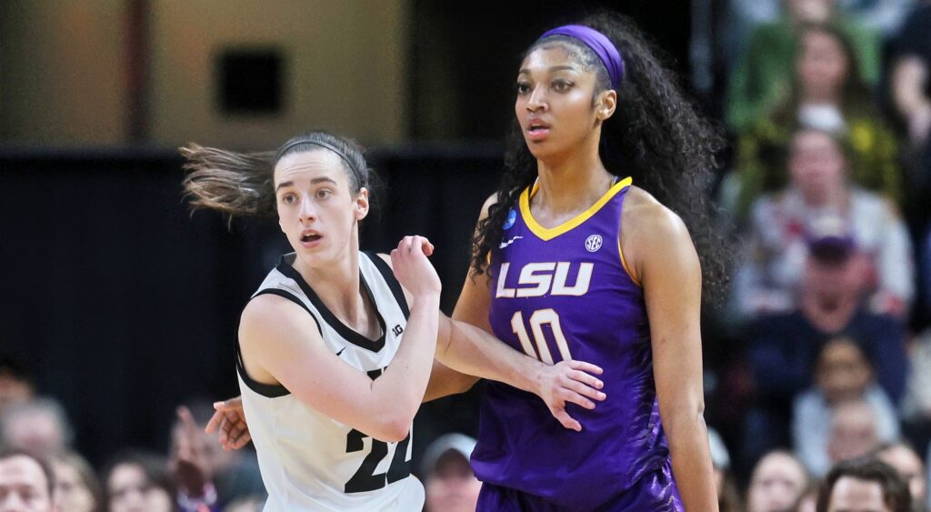 Caitlin Clark (left) and Angel Reese (right) look on during game.