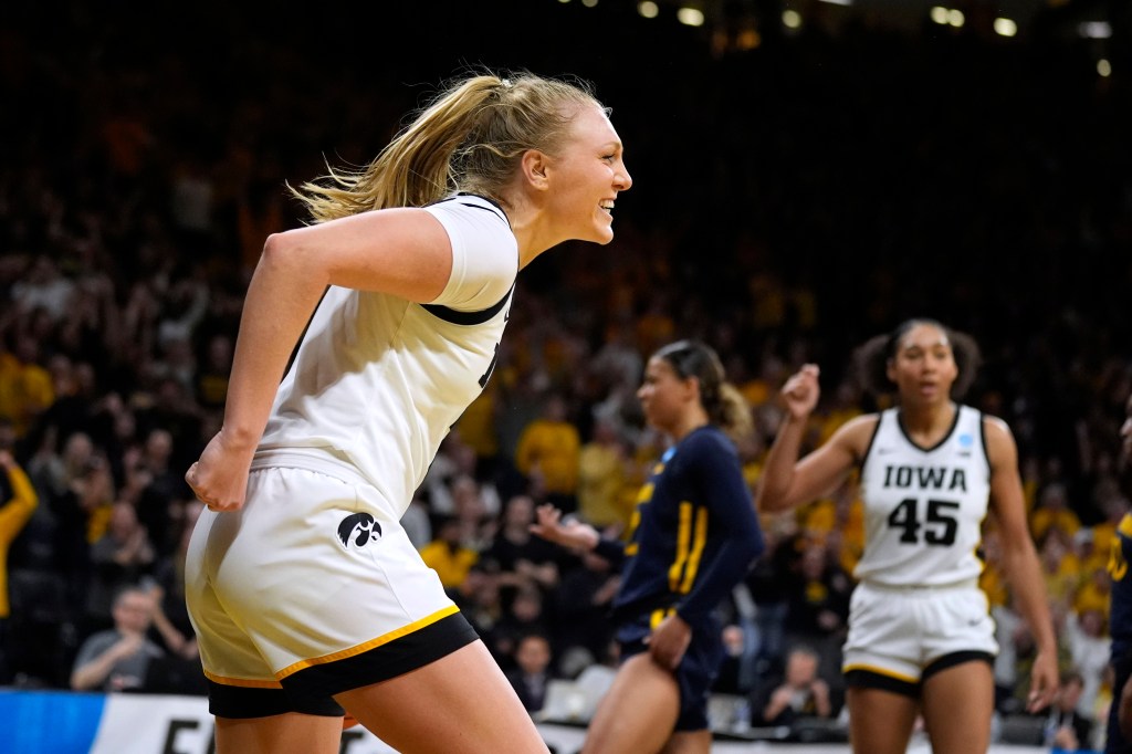 Iowa guard Sydney Affolter celebrating after scoring in a second-round NCAA Tournament game against West Virginia