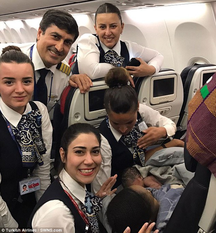 Crew members help a woman give birth on the plane. Photo: Turkish Airlines